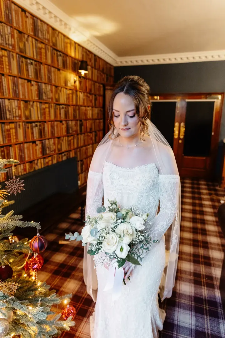 Sam with her bouquet in the library, ready to go
