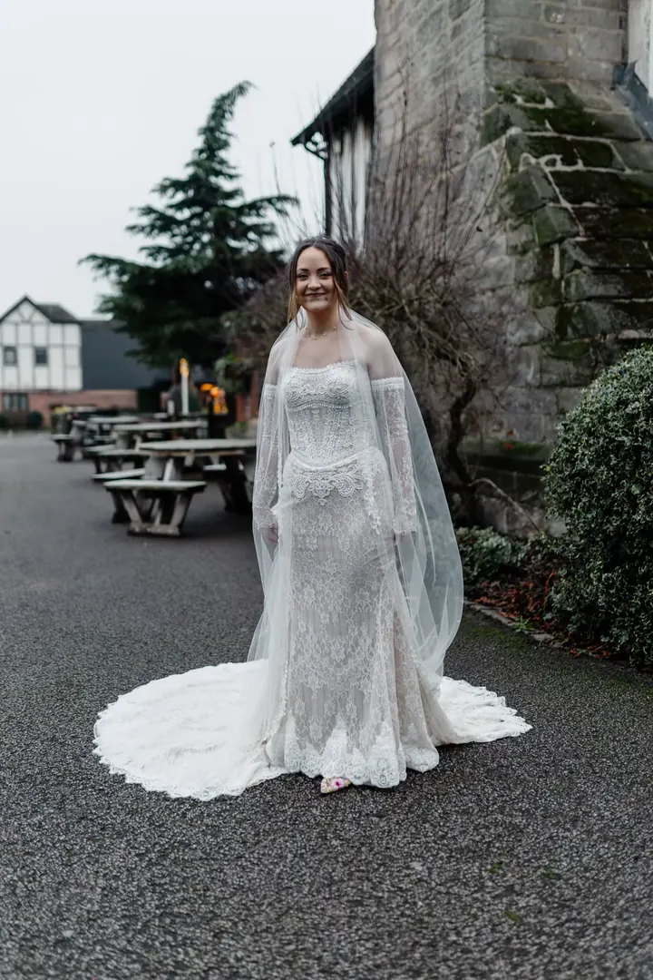 Sam in her lace gown and long veil