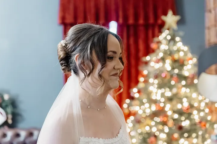 Sam in her veil beside the Christmas tree