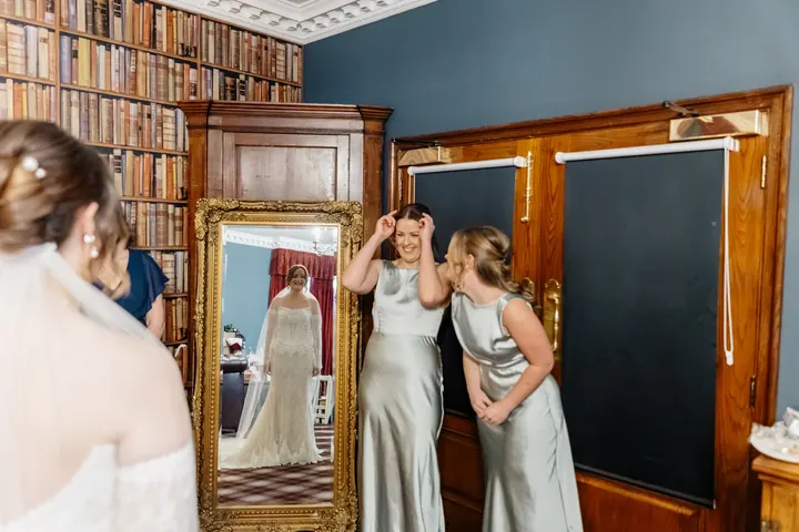 The bridesmaids seeing Sam in her dress for the first time