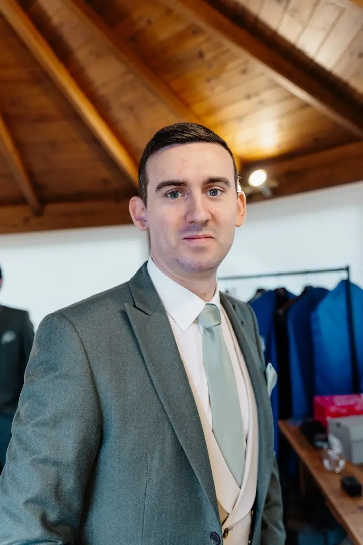 Andrew in his sage green three-piece suit