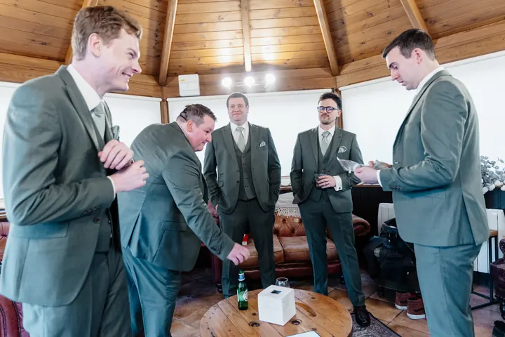 Andrew and the groomsmen getting ready in the gazebo