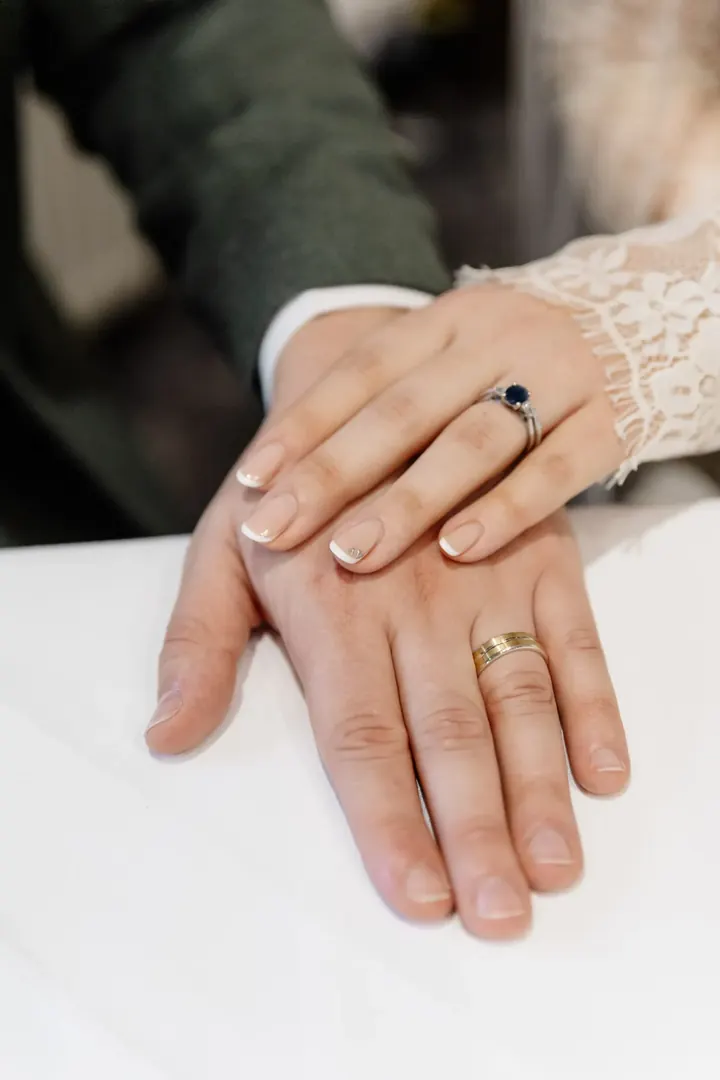 Sam and Andrew&rsquo;s hands with their new wedding rings