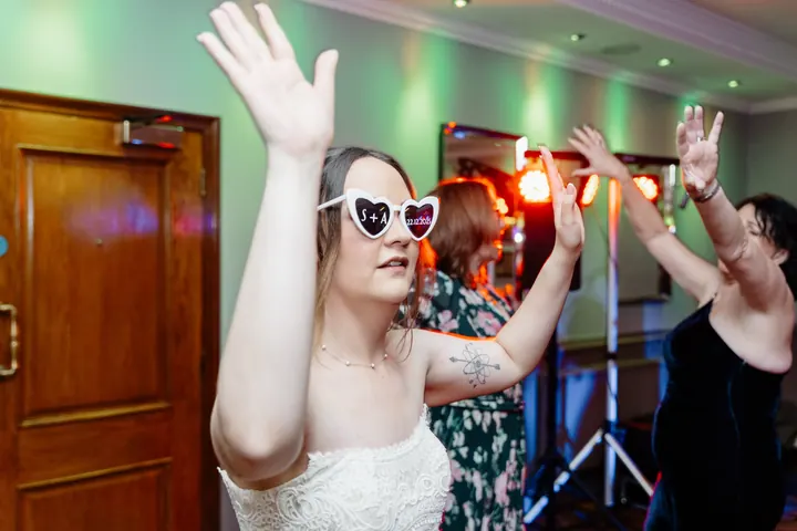 Sam dancing in heart-shaped sunglasses