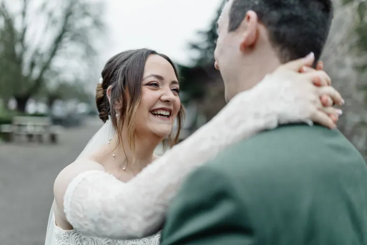 Sam laughing with her arms around Andrew
