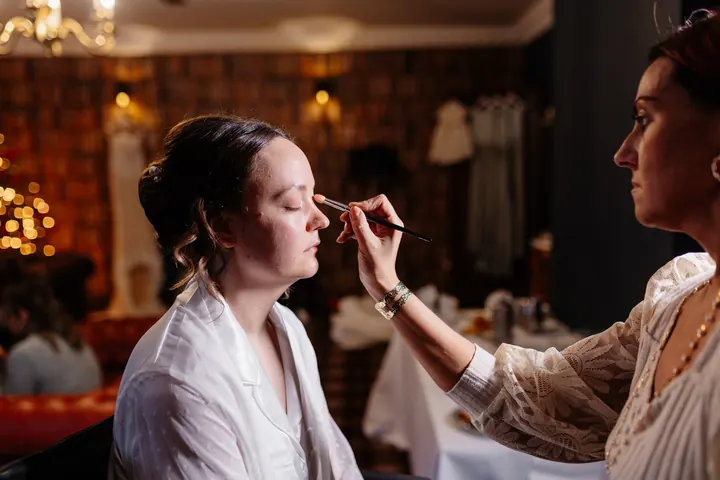 Sam having her make-up done, with the Christmas tree glowing behind