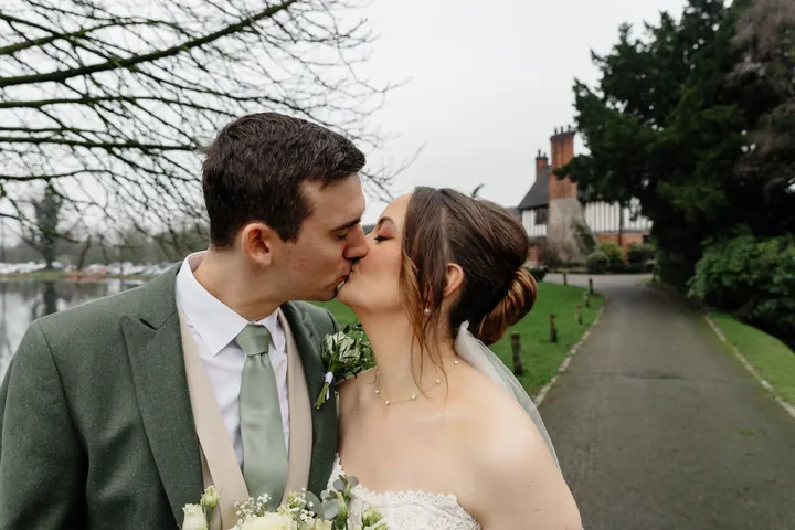 A kiss on the path beside the moat