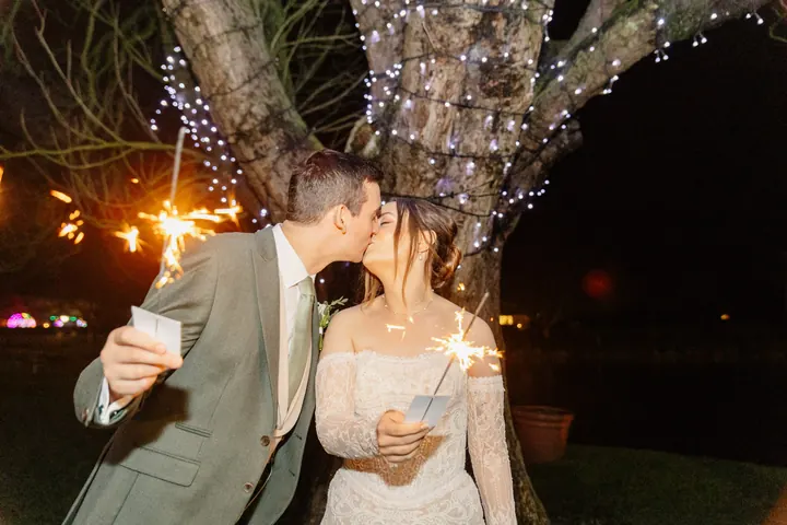 A sparkler-lit kiss under the trees