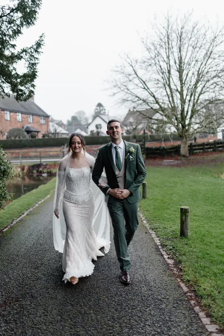 Sam and Andrew walking together through the grounds