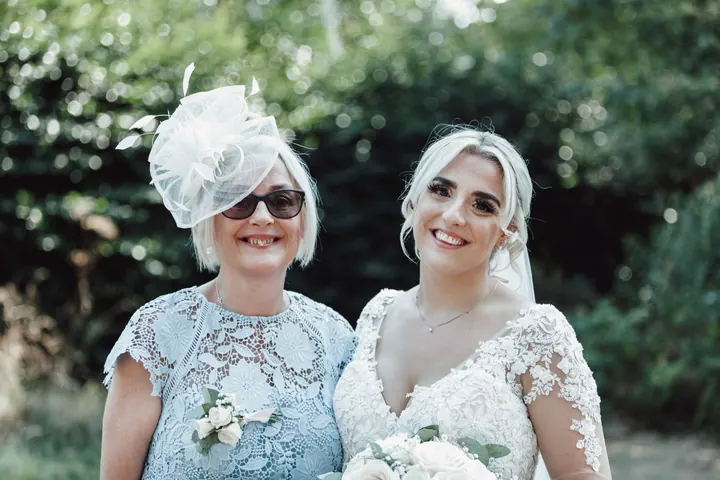 Sarah with a guest in a white fascinator