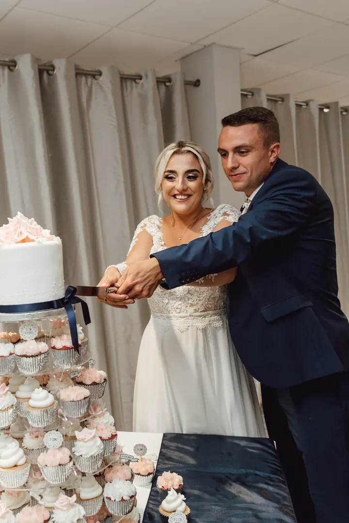 Sarah and Sam cutting the cake