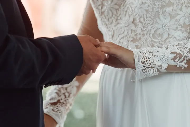 Sam placing the ring on Sarah&rsquo;s finger