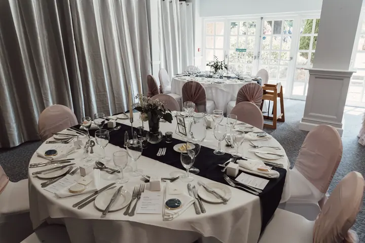 Round tables dressed in white with dark runners