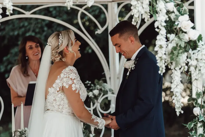 Sarah and Sam sharing a laugh during their vows