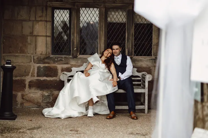 Laura stretched out across Darren&rsquo;s lap on a stone bench