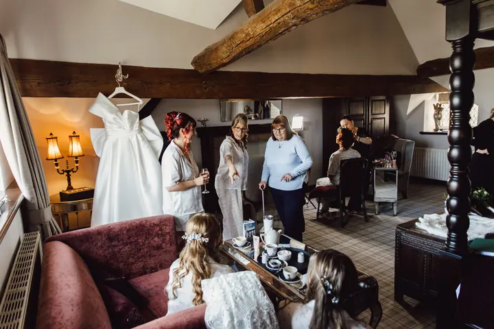 The beamed bridal room with the dress hanging in the window