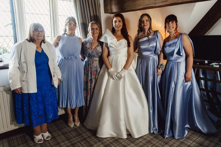 Laura with her bridesmaids in blue satin
