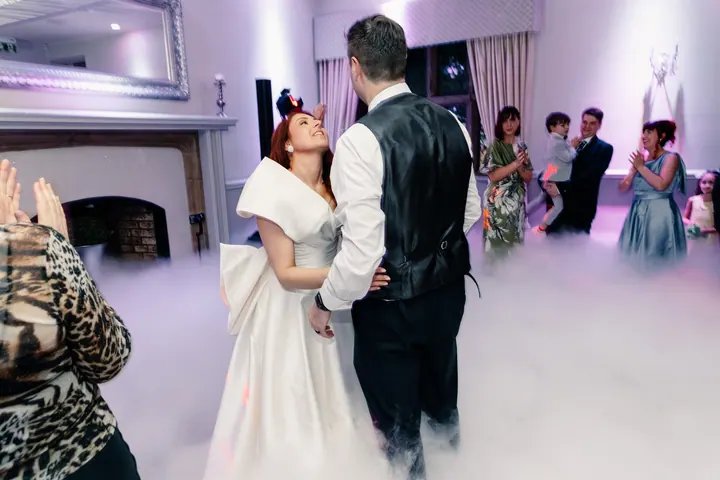 Laura dancing with guests on the checked dancefloor