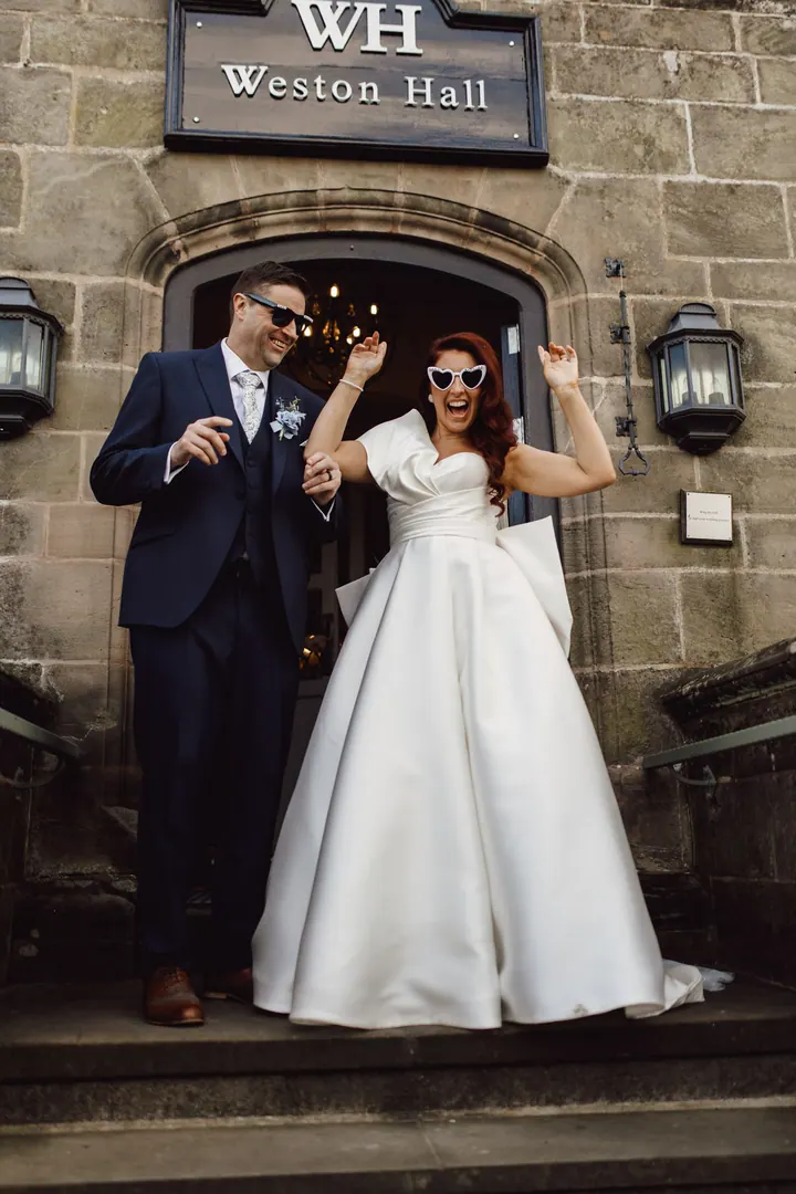 Laura and Darren in the doorway beneath the Weston Hall sign
