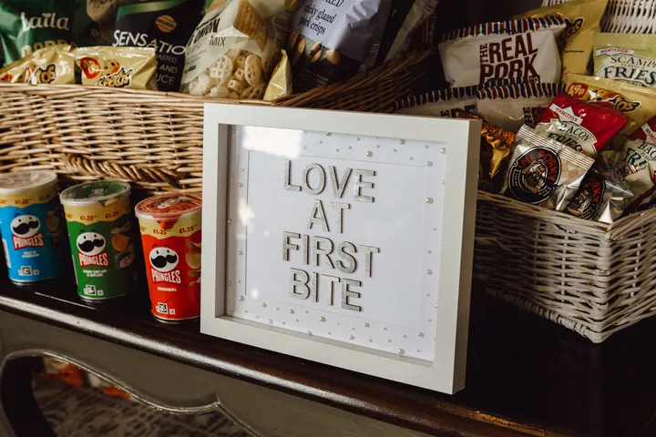 A Love at First Bite sign on a snack table