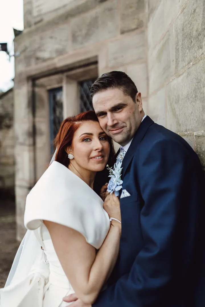 Laura and Darren against an old stone wall